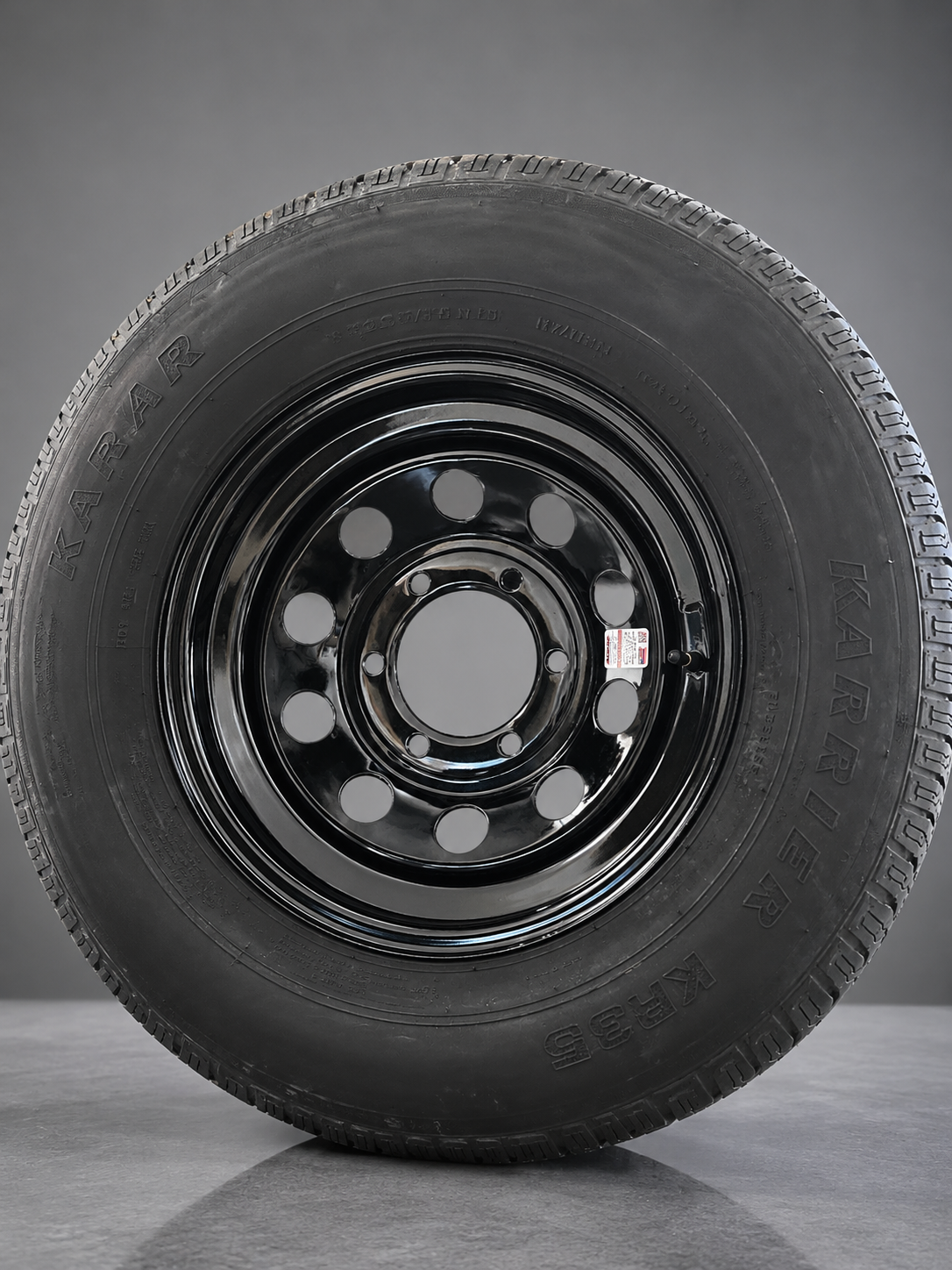 Trailer tire mounted on a black modular wheel