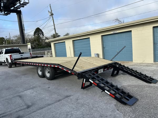 Deckover flatbed trailer rental in Hudson, FL — heavy equipment hauling